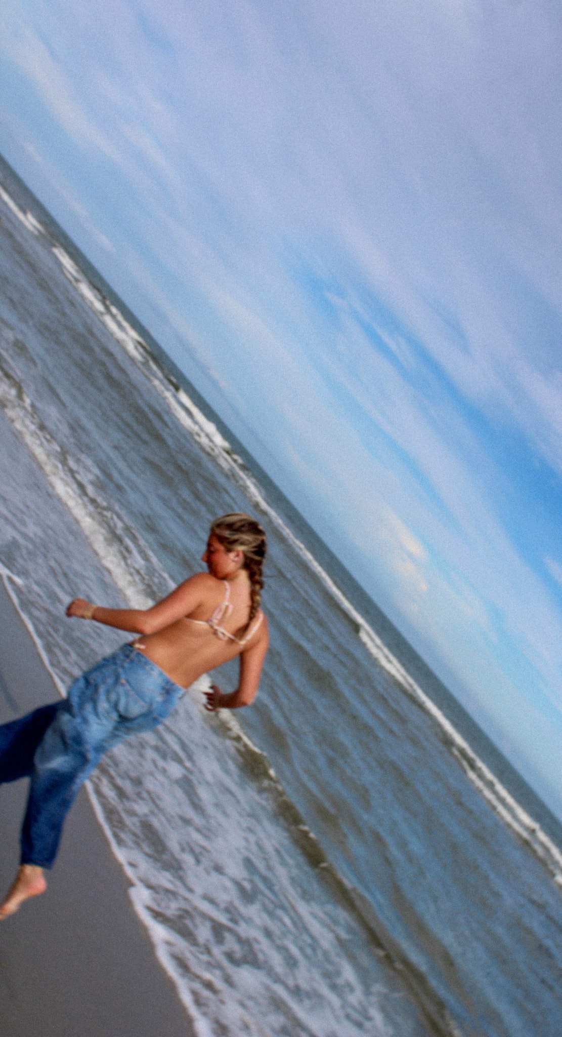 Candid shot running into the ocean, tilted horizon